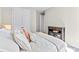 Bright bedroom featuring a decorated bed, dark wood cabinet, and double closet doors at 15710 Oleander Dr, Charlotte, NC 28278