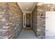 Inviting front entrance featuring a stone facade, covered porch, and a decorative wreath on the brown front door at 15710 Oleander Dr, Charlotte, NC 28278