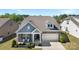 Charming home with stone accents, covered porch, and well-manicured lawn in a beautiful residential neighborhood at 15710 Oleander Dr, Charlotte, NC 28278