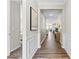 Elegant hallway with hardwood floors, wainscoting, neutral paint, and open view into the living area at 15710 Oleander Dr, Charlotte, NC 28278