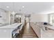 Open-concept kitchen with a large island, pendant lighting, modern appliances, and seamless flow to the living space at 15710 Oleander Dr, Charlotte, NC 28278