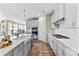 Bright kitchen with white cabinets, gas range, island sink, and stainless steel appliances at 15710 Oleander Dr, Charlotte, NC 28278