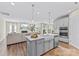 Kitchen island with sink and dishwasher offering open views to living room at 15710 Oleander Dr, Charlotte, NC 28278