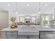 Open kitchen island with a stainless steel dishwasher and a view to the living area at 15710 Oleander Dr, Charlotte, NC 28278