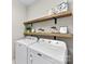 Bright laundry room features floating shelves and modern appliances at 15710 Oleander Dr, Charlotte, NC 28278