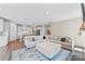 Spacious living area features a large sofa, area rug, and open layout connecting to the modern kitchen at 15710 Oleander Dr, Charlotte, NC 28278
