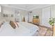 Bright main bedroom featuring a dresser with a TV, a walk-in closet, and ensuite bathroom access at 15710 Oleander Dr, Charlotte, NC 28278