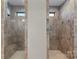 Spacious walk-in shower featuring stylish tilework, a built-in bench, and dual shower heads at 15710 Oleander Dr, Charlotte, NC 28278
