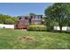 Spacious backyard with lush green lawn, brick home and fenced in yard at 16610 Blackberry Hills Dr, Midland, NC 28107