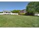 Expansive backyard featuring a well-maintained lawn, white fence, and detached garage at 16610 Blackberry Hills Dr, Midland, NC 28107