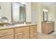 Bright bathroom featuring double sinks with granite countertops, and natural wood cabinets at 16610 Blackberry Hills Dr, Midland, NC 28107