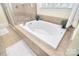 Bright bathroom featuring a large white tub, tile surround, and a separate glass enclosed shower at 16610 Blackberry Hills Dr, Midland, NC 28107