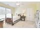 Charming bedroom with a four-poster bed, vintage sewing table, and ample natural light at 16610 Blackberry Hills Dr, Midland, NC 28107