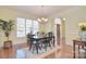 Cozy dining room with a chandelier, wood floors, and a view of the front entrance at 16610 Blackberry Hills Dr, Midland, NC 28107