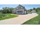 Expansive view of the house with a long driveway that leads to the garage and a well-maintained lawn at 16610 Blackberry Hills Dr, Midland, NC 28107