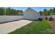 Detached garage with white fence, well-manicured lawn and lush green trees at 16610 Blackberry Hills Dr, Midland, NC 28107