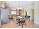 Open kitchen features an island, tile floors, light wood cabinets, stainless appliances, and a breakfast table set for two at 16610 Blackberry Hills Dr, Midland, NC 28107