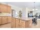 Bright kitchen with granite island, natural wood cabinets, and bar stool seating at 16610 Blackberry Hills Dr, Midland, NC 28107