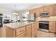 A kitchen island with granite countertops, light wood cabinets, and stainless steel appliances at 16610 Blackberry Hills Dr, Midland, NC 28107