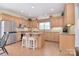 Spacious kitchen with an island, bar stool seating, stainless appliances, granite countertops and natural wood cabinets at 16610 Blackberry Hills Dr, Midland, NC 28107