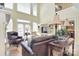 Bright and airy living room with tall windows, built-in shelving, and elegant furnishings at 16610 Blackberry Hills Dr, Midland, NC 28107