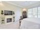 A comfortable main bedroom featuring a fireplace, shelving, and a large window at 16610 Blackberry Hills Dr, Midland, NC 28107