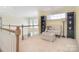 Cozy sitting area with cushioned seating, dark wood shelving, and neutral carpeting at 16610 Blackberry Hills Dr, Midland, NC 28107