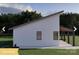 Side view of a modern farmhouse featuring clean lines, a covered patio, and well-maintained landscaping at 180 Nc 742 Hwy, Wadesboro, NC 28170