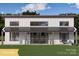 Stunning two-story modern farmhouse with a covered porch, white siding, black trim, and manicured front yard at 180 Nc 742 Hwy, Wadesboro, NC 28170