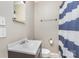 Modest bathroom with blue and white striped shower curtain and updated sink and toilet at 2001 S Main St, Kannapolis, NC 28081