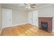 Bedroom featuring hardwood floors, red brick fireplace, and neutral color palette at 2001 S Main St, Kannapolis, NC 28081