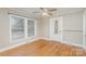 Bright bedroom with hardwood floors, ceiling fan, and updated double windows at 2001 S Main St, Kannapolis, NC 28081