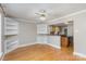 Bright dining room with hardwood floors, built-in shelving, and open view to the kitchen at 2001 S Main St, Kannapolis, NC 28081