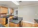 Well-lit kitchen featuring wooden cabinets, granite countertops, and modern appliances at 2001 S Main St, Kannapolis, NC 28081