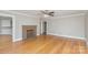 Open-concept living room with hardwood floors, a brick fireplace, and a view to kitchen at 2001 S Main St, Kannapolis, NC 28081