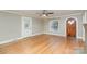 Bright living room with hardwood floors, vintage door and window, and a ceiling fan at 2001 S Main St, Kannapolis, NC 28081