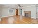 Spacious living room with hardwood floors, a brick fireplace, and a vintage front door at 2001 S Main St, Kannapolis, NC 28081