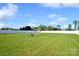 Expansive backyard features green lawn and a seating area with string lights, perfect for outdoor relaxation and entertaining at 221 Mountain Island Dr, Statesville, NC 28677