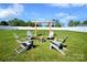 Backyard features a seating area with four chairs around a fire pit and wooden structure at 221 Mountain Island Dr, Statesville, NC 28677