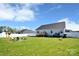 The large, grassy backyard includes a fire pit area, deck and white fence at 221 Mountain Island Dr, Statesville, NC 28677