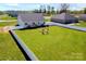 Spacious backyard with a white fence, wooden deck, and wooden swing set at 221 Mountain Island Dr, Statesville, NC 28677