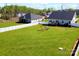 Large backyard with a white fence, wooden deck, and outdoor seating area at 221 Mountain Island Dr, Statesville, NC 28677