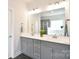Bathroom featuring double sinks, gray cabinets, quartz countertops, and modern lighting at 221 Mountain Island Dr, Statesville, NC 28677