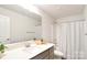 Bathroom featuring a neutral vanity, shower-tub combination, and large mirror at 221 Mountain Island Dr, Statesville, NC 28677