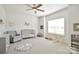 Bright room featuring a ceiling fan, chair, toys, play gym, and ample natural light from a large window at 221 Mountain Island Dr, Statesville, NC 28677