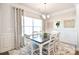Formal dining room with wainscoting, decorative art, and a chandelier at 221 Mountain Island Dr, Statesville, NC 28677