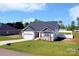 New construction home with two car garage and stone accents in a landscaped yard at 221 Mountain Island Dr, Statesville, NC 28677