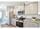 Well-equipped kitchen featuring stainless steel appliances, gray cabinets, and granite countertops at 221 Mountain Island Dr, Statesville, NC 28677