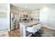 Modern kitchen features stainless steel appliances, gray cabinets, and a granite island with barstool seating at 221 Mountain Island Dr, Statesville, NC 28677