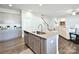 Bright kitchen features stainless steel appliances, gray cabinets, and a granite island open to the living area at 221 Mountain Island Dr, Statesville, NC 28677